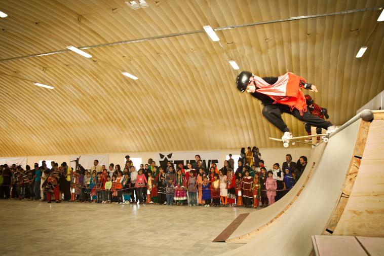 Girl skateboarding at event at Skateistan Kabul