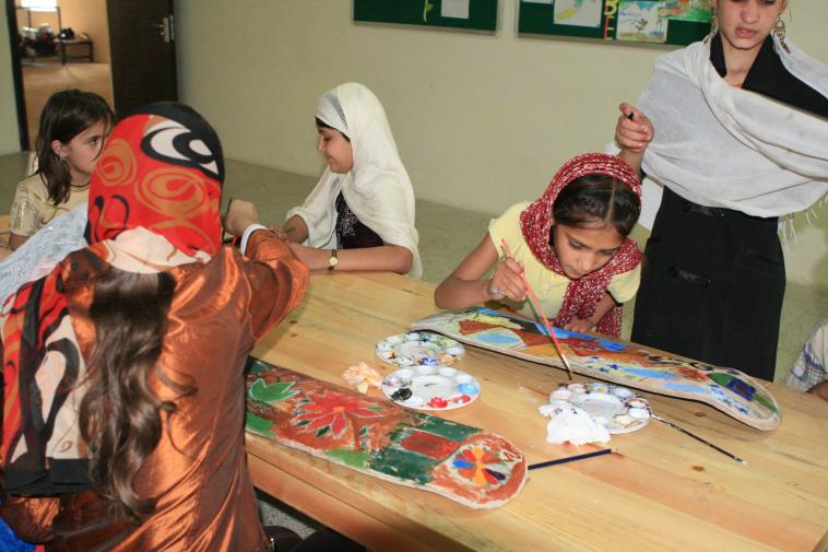 Girls painting on skateboards at Skateistan Afghanistan